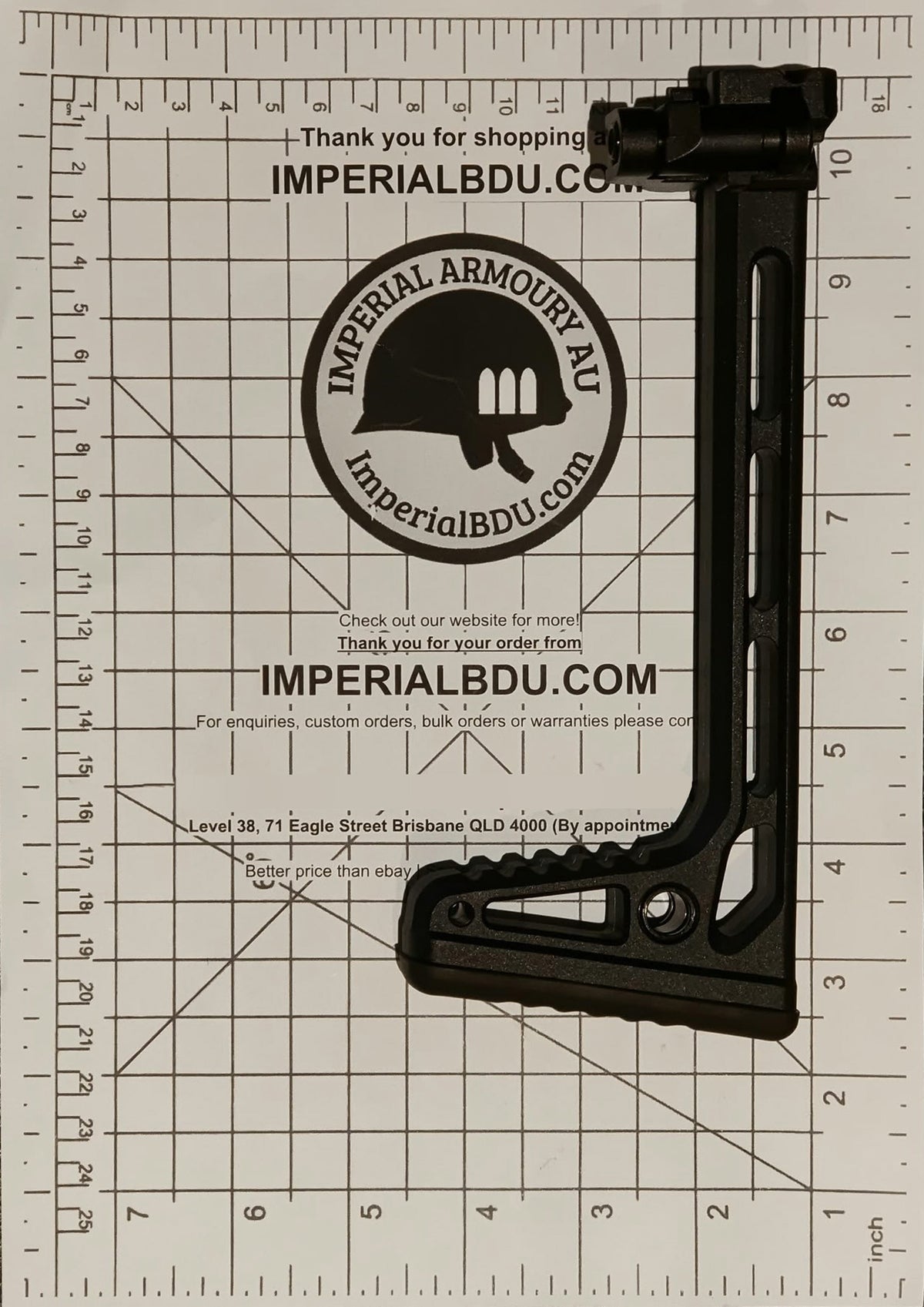 A black MCX MPX folding stock adjustable rifle stock buttstock with a sling attachment, displayed on a white grid measurement mat with Imperial BDU branding.
